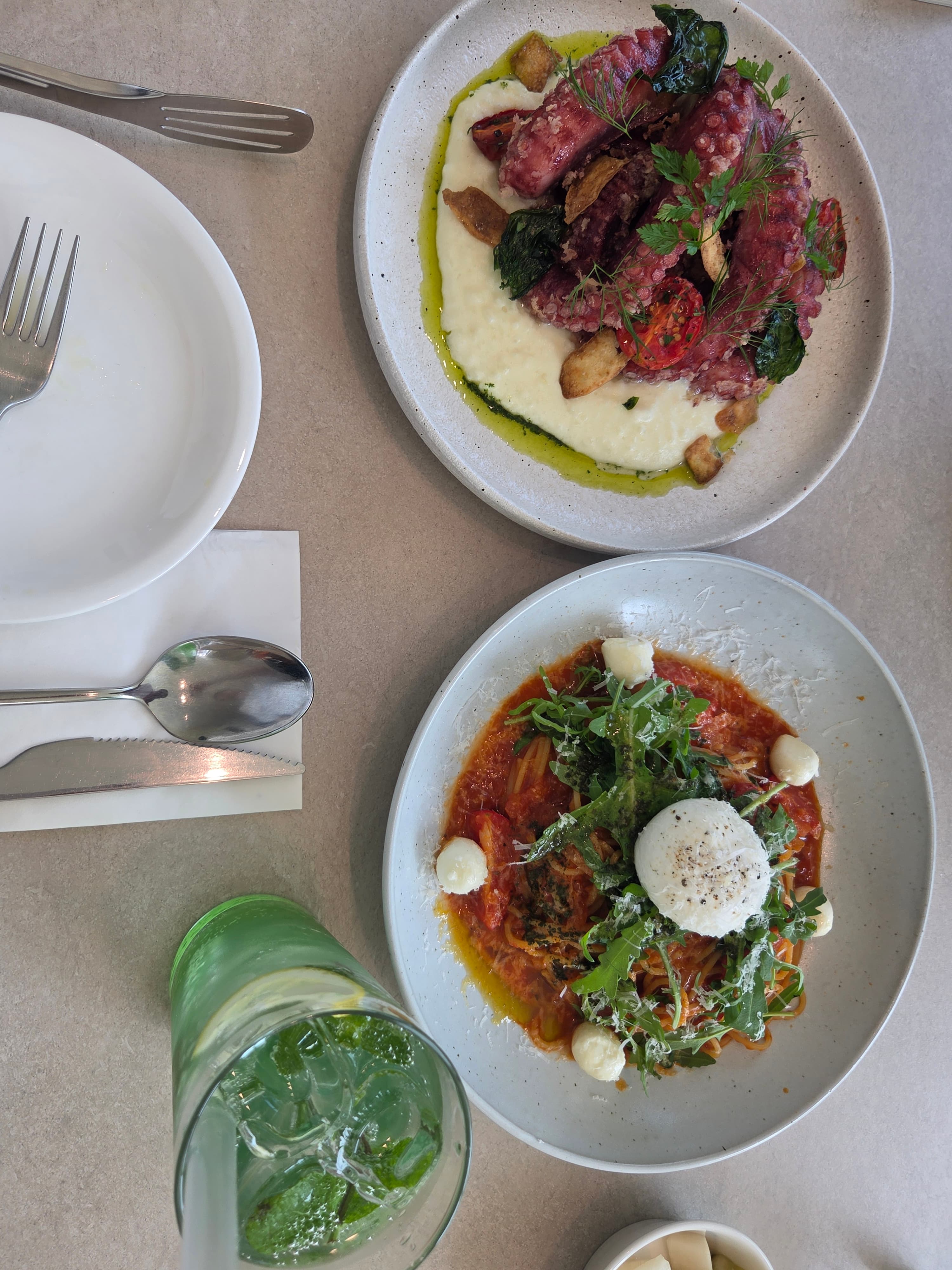 Full table spread at Seasoner Jeonju with the octopus dish, burrata pasta, and a virgin mojito