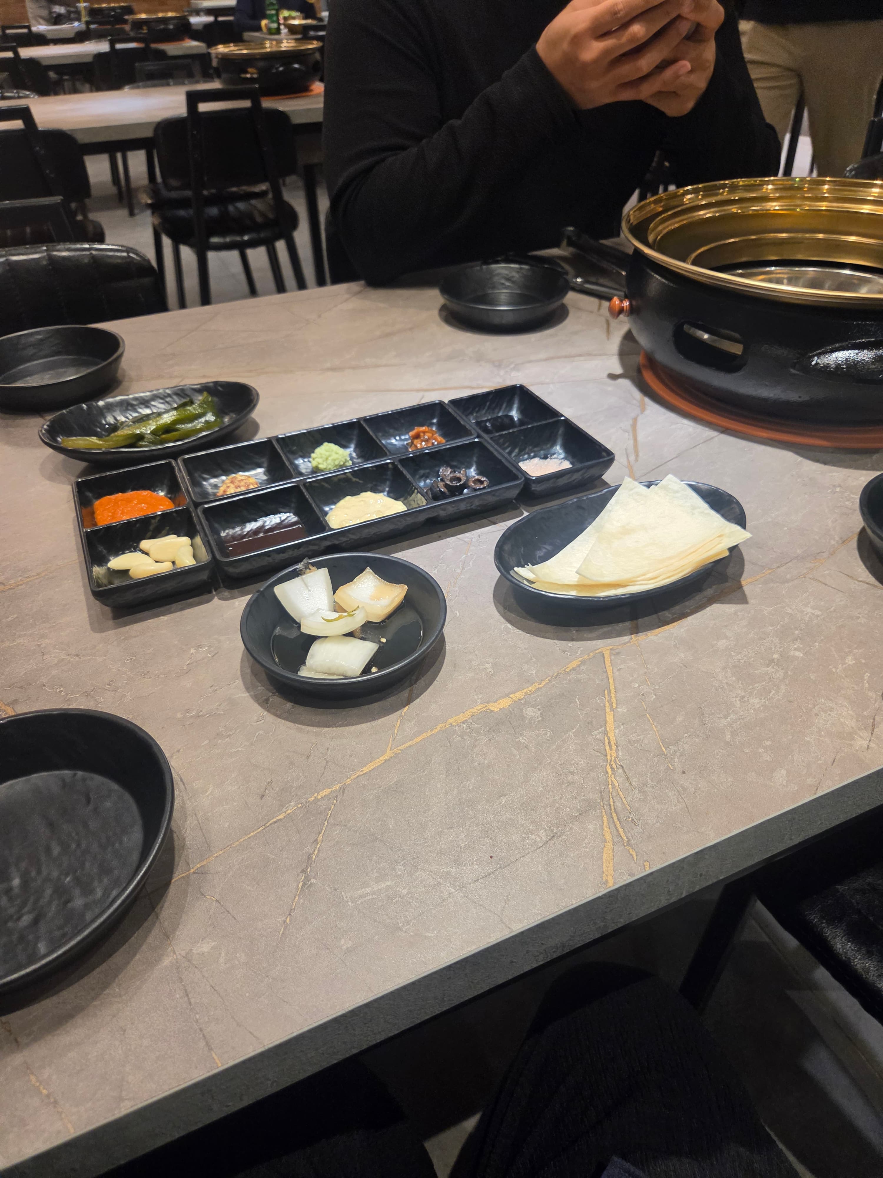 Side dish spread at Midam 1974 including wasabi, ssamjang, garlic, pickled vegetables, and thin tortilla wraps for Korean BBQ