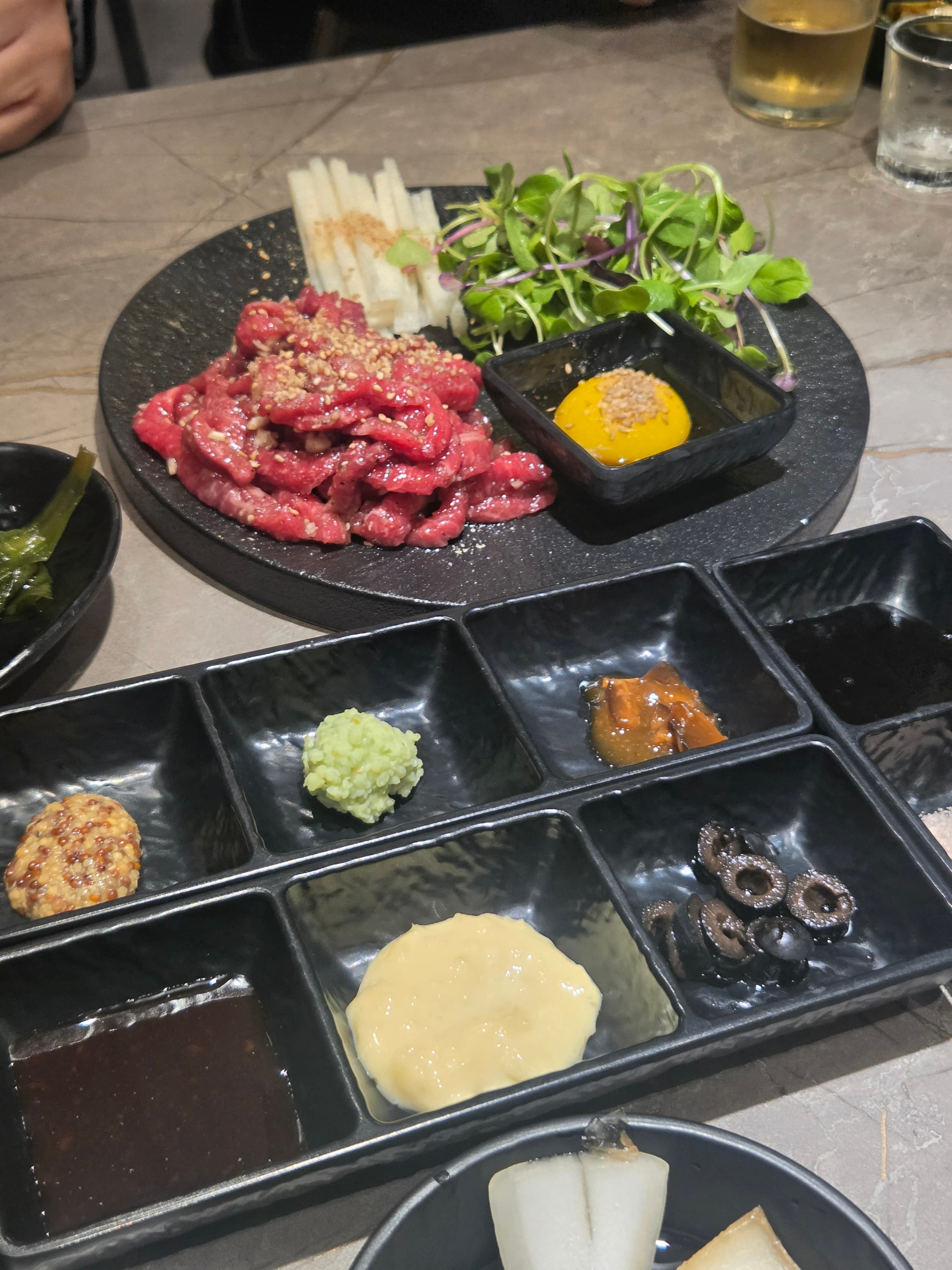 1++ grade Korean beef yukhoe with raw egg yolk, sweet soy sauce, pear strips and microgreens at Midam 1974